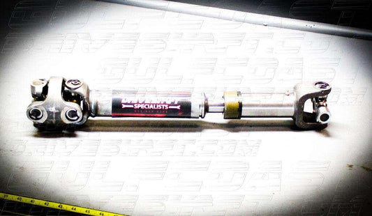 New 2004-06 Jeep LJ Wrangler driveshaft with solid cross U-joints, silver tubing, and red branding. Custom lengths available.